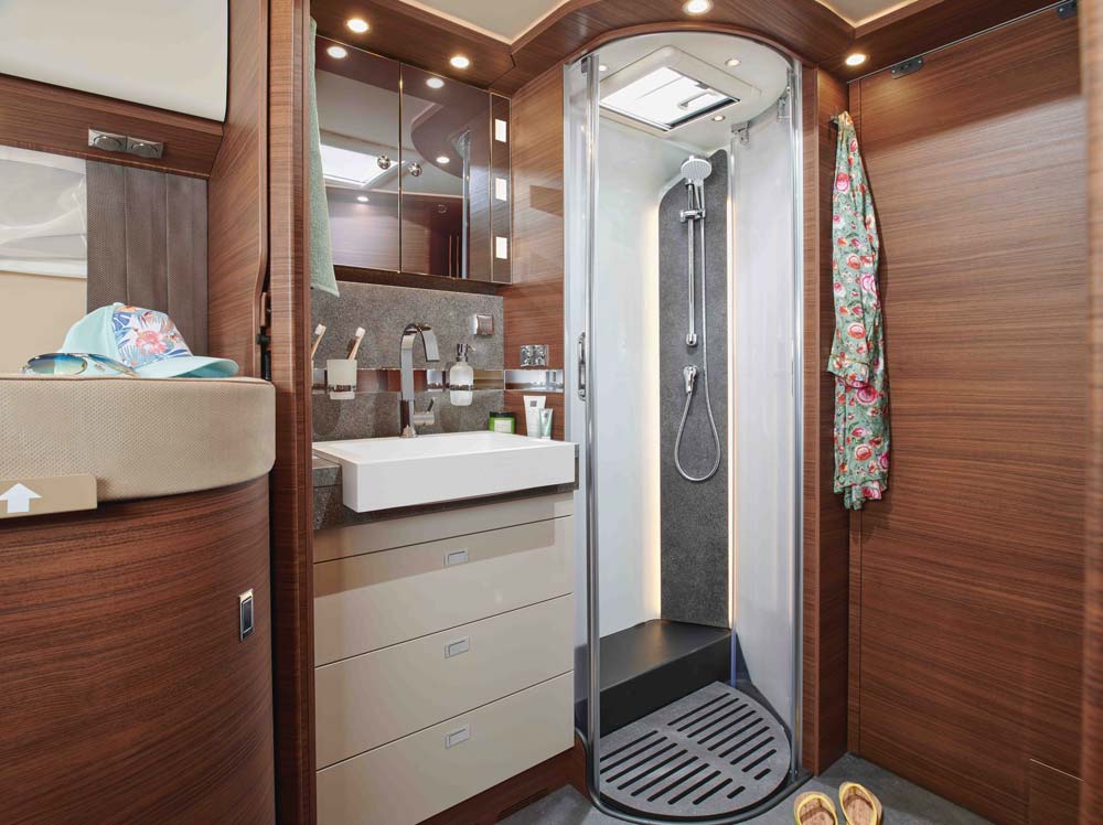 Modern Badezimmer mit Holzverkleidung, runder Dusche, buntem Handtuch und Spiegel
